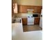 Kitchen boasts wood cabinets, white appliances, and light countertops at 4372 Paradise Cove Ct, Kissimmee, FL 34746