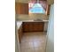 Kitchen with light countertops, wood cabinets, and a double sink at 4372 Paradise Cove Ct, Kissimmee, FL 34746