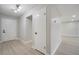 Clean hallway with light wood floors and white doors and walls at 4505 Haylock Dr, Orlando, FL 32807