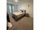 Bright bedroom with a queen-size bed and nightstand at 46 Willow Ln, Kissimmee, FL 34759