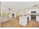 Open concept kitchen with white cabinets, marble countertops, and stainless steel appliances at 651 Celebration Ave # 651, Celebration, FL 34747