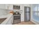 Stainless steel appliances and white cabinets in a corner kitchen at 651 Celebration Ave # 651, Celebration, FL 34747