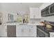 White kitchen with stainless steel appliances and a marble island at 651 Celebration Ave # 651, Celebration, FL 34747