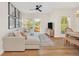 Spacious living room featuring a sectional sofa, hardwood floors, and access to a balcony at 651 Celebration Ave # 651, Celebration, FL 34747