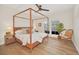 Main bedroom with a canopy bed, hardwood floors, and access to a balcony at 651 Celebration Ave # 651, Celebration, FL 34747