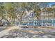 Three story building with light blue exterior and balconies along a tree-lined street at 651 Celebration Ave # 651, Celebration, FL 34747