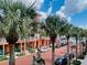 Palm tree-lined street with shops and buildings at 651 Celebration Ave # 651, Celebration, FL 34747