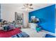 Bright bedroom with blue walls, a double bed, and ample closet space at 661 Swallowtail Dr, Haines City, FL 33844