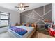 Spacious bedroom with gray accent wall and a comfy double bed at 661 Swallowtail Dr, Haines City, FL 33844