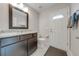 Bathroom with granite countertop, dark brown vanity, and a toilet at 7017 Bridle Path, Saint Cloud, FL 34771