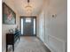 Entryway with dark wood floors and a console table at 7017 Bridle Path, Saint Cloud, FL 34771