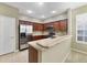 Modern kitchen with stainless steel appliances and wood cabinets at 7136 Red Lantern Dr # 7136, Harmony, FL 34773