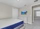 Spacious bedroom with a queen bed and mounted TV at 7430 Marker Ave, Kissimmee, FL 34747