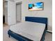 Bedroom with a queen bed and mounted TV at 7430 Marker Ave, Kissimmee, FL 34747