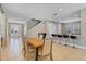 Dining area with wood table and view into kitchen at 7430 Marker Ave, Kissimmee, FL 34747