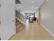 View down hallway showcasing tile floors and staircase at 7430 Marker Ave, Kissimmee, FL 34747