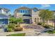 Two-story house with a gray garage door and brick facade at 7430 Marker Ave, Kissimmee, FL 34747