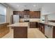 Kitchen with dark cabinets, granite counters, and island at 7430 Marker Ave, Kissimmee, FL 34747