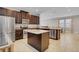 Kitchen with dark cabinets, granite counters, and island at 7430 Marker Ave, Kissimmee, FL 34747