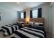Guest bedroom with two twin-size beds, nightstands, and stylish decor at 800 Benoi Dr, Davenport, FL 33896