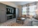 Living room with built-in entertainment center and large TV at 800 Benoi Dr, Davenport, FL 33896