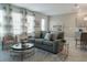 Bright living room features a comfy sofa and large windows at 800 Benoi Dr, Davenport, FL 33896