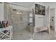 A sleek bathroom features a glass-enclosed shower with gray tile, a rain shower head, and a modern bench at 820 Windlass Ct, Kissimmee, FL 34746