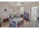 A well-lit bedroom featuring wood floors, pink walls, and plenty of space for toys and activities at 820 Windlass Ct, Kissimmee, FL 34746