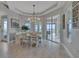 Well-lit dining area with modern chandelier, with bright light coming from the large sliding glass doors with a view at 820 Windlass Ct, Kissimmee, FL 34746