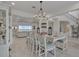 Open dining area with modern chandelier and ample seating, and a view of the stairs at 820 Windlass Ct, Kissimmee, FL 34746