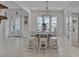 Open dining area boasts a modern chandelier and ample seating with a large glass-paneled front door in the background at 820 Windlass Ct, Kissimmee, FL 34746