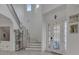 Bright entryway with elegant staircase and decorative front door at 820 Windlass Ct, Kissimmee, FL 34746