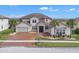 Two-story house with tile roof, large windows, and driveway at 820 Windlass Ct, Kissimmee, FL 34746