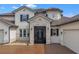 Two-story house with a brown tile roof and stone accents around the entrance at 820 Windlass Ct, Kissimmee, FL 34746