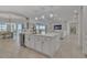Modern kitchen with a large center island featuring stone countertops, seating, and pendant lighting at 820 Windlass Ct, Kissimmee, FL 34746