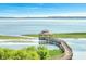 Wooden walkway leads to a gazebo overlooking a serene lake at 820 Windlass Ct, Kissimmee, FL 34746
