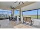 This screened lanai has beautiful views, tiled floors, ceiling fans, a dining set, and a comfortable seating area at 820 Windlass Ct, Kissimmee, FL 34746