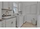 Clean laundry room with built-in cabinets and modern appliances at 820 Windlass Ct, Kissimmee, FL 34746
