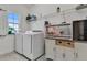 Functional laundry room with washer, dryer, and storage at 820 Windlass Ct, Kissimmee, FL 34746