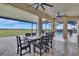 Covered patio with outdoor dining table, seating, and a view of the pool at 820 Windlass Ct, Kissimmee, FL 34746