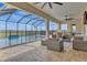 Covered patio with pool, outdoor kitchen, and seating area at 820 Windlass Ct, Kissimmee, FL 34746