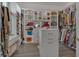 A spacious walk-in closet provides ample storage with custom shelving, cabinets, drawers, and room for accessories at 820 Windlass Ct, Kissimmee, FL 34746