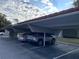 Covered parking area with several cars parked underneath at 935 Northern Dancer Way # 105, Casselberry, FL 32707