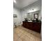 Primary bathroom with dark wood cabinets and granite vanity at 1375 Tuscana Ln # 1106, Davenport, FL 33896