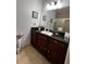 Bathroom features granite countertop and dark wood cabinets at 1375 Tuscana Ln # 1106, Davenport, FL 33896