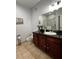 Bathroom features dark wood cabinets and granite countertop at 1375 Tuscana Ln # 1106, Davenport, FL 33896
