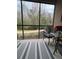 Screened porch with striped rug and wooded views at 1375 Tuscana Ln # 1106, Davenport, FL 33896