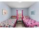 Two twin beds in a Minnie Mouse themed bedroom at 1017 Park Ridge Cir, Kissimmee, FL 34746