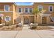 Front view of a two-story tan building with white shutters and landscaping at 1017 Park Ridge Cir, Kissimmee, FL 34746