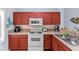 Updated kitchen with ample cabinetry, microwave, and stainless steel sink at 1017 Park Ridge Cir, Kissimmee, FL 34746